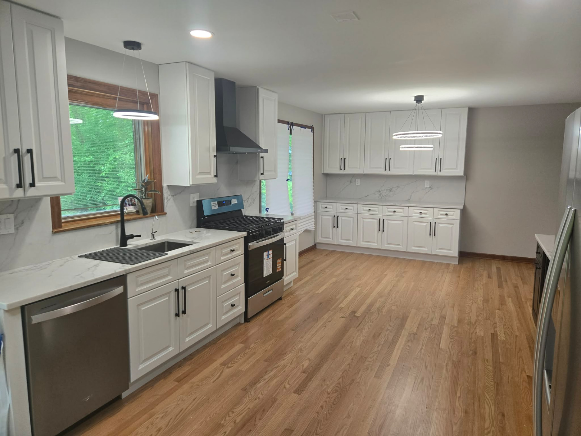 After: remodeled Lisle kitchen with white raised-panel cabinets and quartz island